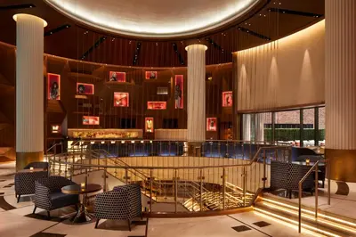 a lobby with chairs and a staircase in a building at Hard Rock Hotel New York in New York