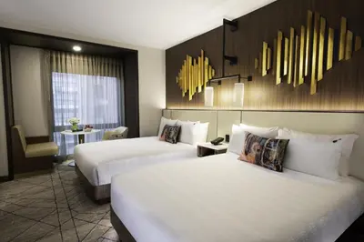 a hotel room with two beds and a table at Hard Rock Hotel New York in New York