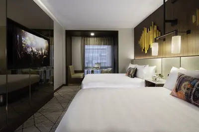 a hotel room with two beds and a table at Hard Rock Hotel New York in New York