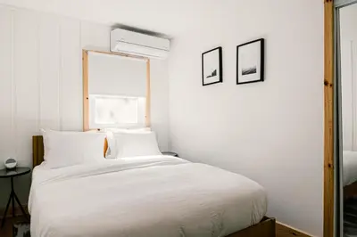 a bedroom with a white bed with two pillows at The Rex in Greentown