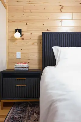 a bedroom with a bed and a nightstand next to a bed at The Rex in Greentown