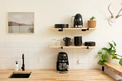 a kitchen with white tiled walls and wooden counters at The Rex in Greentown