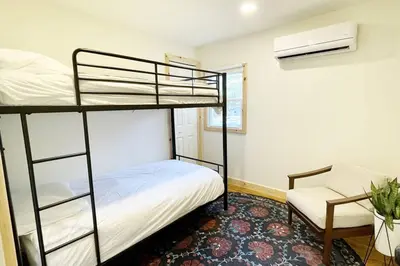a bedroom with a bunk bed and a chair at The Rex in Greentown