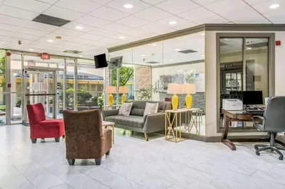 a lobby with chairs and a couch and a desk at Quality Inn & Suites York East in York
