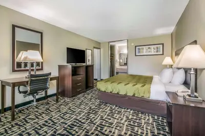 a hotel room with a bed and a desk at Quality Inn & Suites York East in York