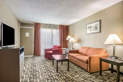 a hotel room with a couch and a television at Quality Inn & Suites York East in York