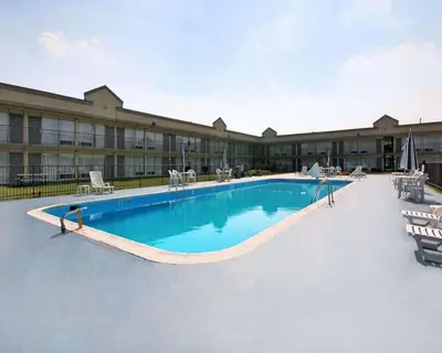 a large swimming pool in front of a hotel at Quality Inn & Suites York East in York