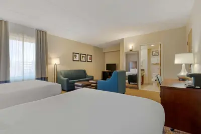 a hotel room with a bed and a living room at Comfort Inn Mechanicsburg - Harrisburg South in Mechanicsburg