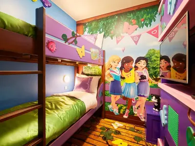 a bedroom with bunk beds with a wall mural of barbie at LEGOLAND New York Resort in Goshen