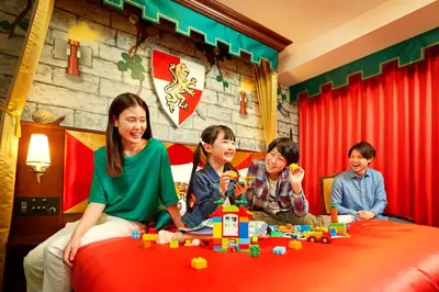 a group of children sitting on a bed playing with legos at LEGOLAND New York Resort in Goshen