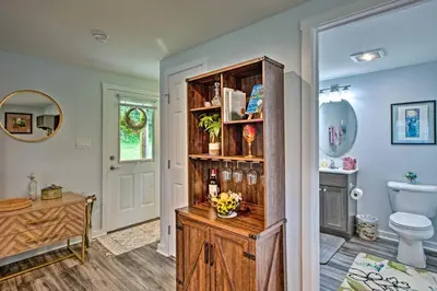 a bathroom with a toilet and a wooden cabinet at 15 Mi to Camelback Resort! The Overlook Home in Brodheadsville