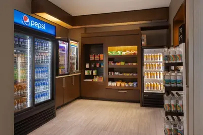 a grocery store aisle with bottles of soda at SpringHill Suites by Marriott Newark International Airport in Newark