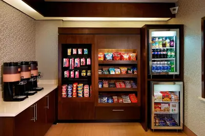 a room with a refrigerator and some drinks at SpringHill Suites by Marriott Newark International Airport in Newark