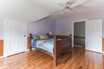 a bedroom with a bed and a ceiling fan at Mountain View Victorian with Convenient Location and Lots of Space tp Play farmhouse in Napanoch