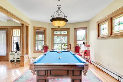 a pool table in a room with windows at Mountain View Victorian with Convenient Location and Lots of Space tp Play farmhouse in Napanoch