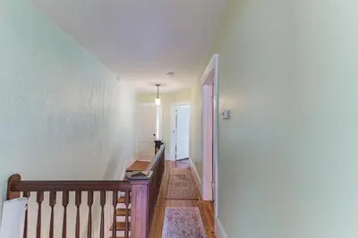 a hallway with a staircase leading to a room at Mountain View Victorian with Convenient Location and Lots of Space tp Play farmhouse in Napanoch