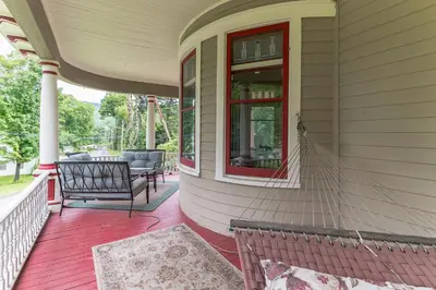 a porch of a house with a bench and a window at Mountain View Victorian with Convenient Location and Lots of Space tp Play farmhouse in Napanoch