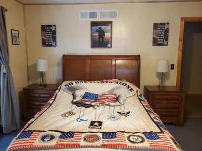 a bed with an american flag quilt on it at Snyder's Knob in Millerstown