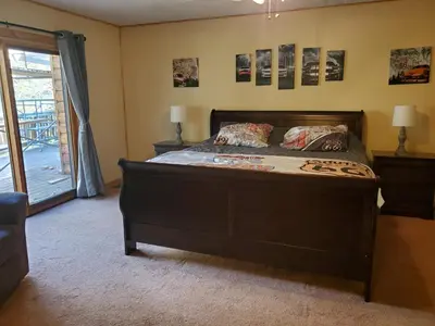 a bedroom with a large bed with a wooden headboard at Snyder's Knob in Millerstown