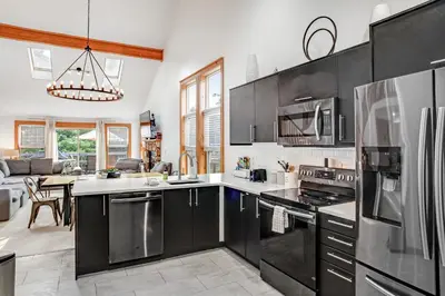 a kitchen with stainless steel appliances and a living room at Northridge 363 in Tannersville