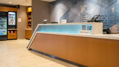 a lobby of a store with a checkout counter at SpringHill Suites by Marriott Woodbridge in Woodbridge