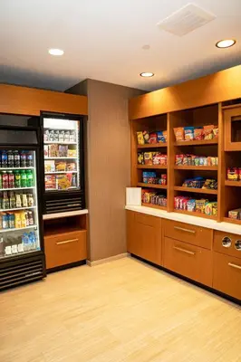 a grocery store aisle with a refrigerator at SpringHill Suites by Marriott Woodbridge in Woodbridge