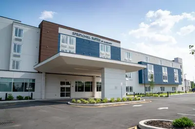 a building with a parking lot in front of it at SpringHill Suites by Marriott Woodbridge in Woodbridge