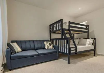 a living room with a couch and a loft bed at Scandi Lakefront Condo Near Big Boulder Ski! in Lake Harmony