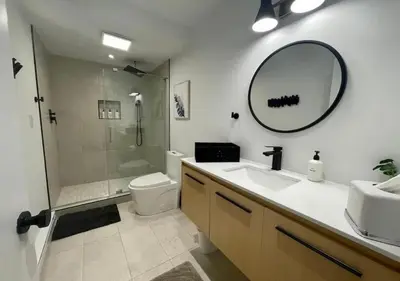 a bathroom with a sink and a shower and a mirror at Scandi Lakefront Condo Near Big Boulder Ski! in Lake Harmony
