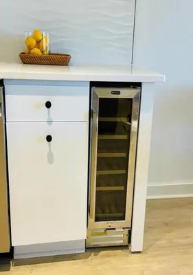 a white counter top with a refrigerator in a kitchen at Scandi Lakefront Condo Near Big Boulder Ski! in Lake Harmony