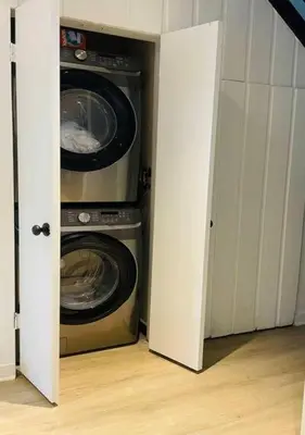 a laundry room with a washer and dryer at Scandi Lakefront Condo Near Big Boulder Ski! in Lake Harmony