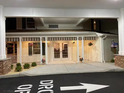 a white house with an exit sign in front of it at Country Inn of Hazlet in Hazlet