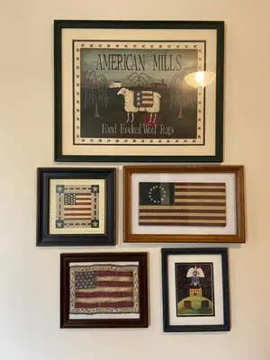 a group of framed pictures hanging on a wall at Country Inn of Hazlet in Hazlet
