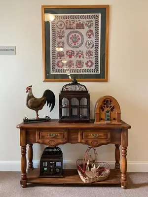 a table with a bird cage on top of it at Country Inn of Hazlet in Hazlet