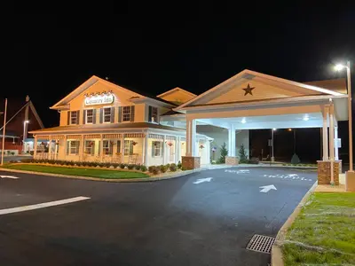 a large building with a gas station at night at Country Inn of Hazlet in Hazlet