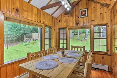 a dining room with a wooden table and chairs at Steps to Lake Tafton Cottage with Fire Pit and Grill in Tafton