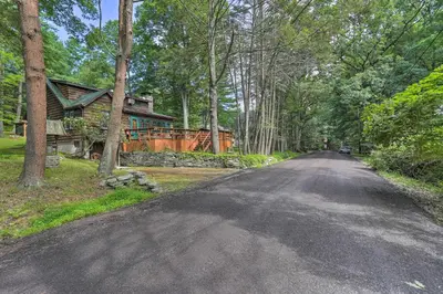 a road leading to a house in the woods at Steps to Lake Tafton Cottage with Fire Pit and Grill in Tafton