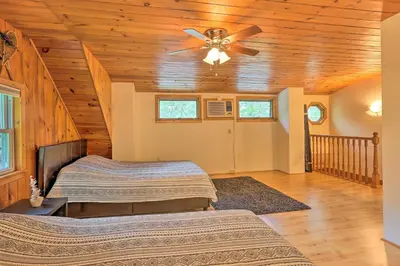 a bedroom with two beds and a ceiling fan at Steps to Lake Tafton Cottage with Fire Pit and Grill in Tafton
