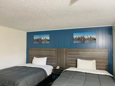 two beds sitting next to each other in a bedroom at Crown Inn in Linden