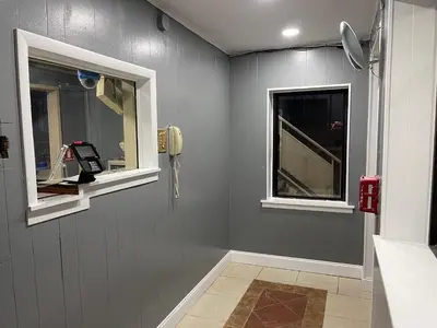 a bathroom with two windows and a phone on the wall at Crown Inn in Linden
