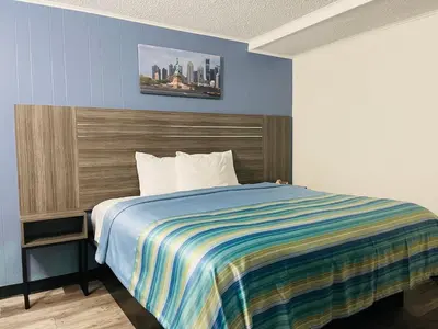 a bedroom with a bed with a colorful striped blanket at Crown Inn in Linden