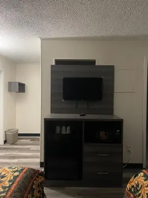 a living room with a flat screen tv on a entertainment center at Crown Inn in Linden