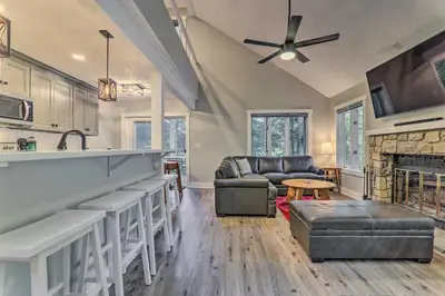 a kitchen and living room with a couch and a fireplace at Unwind Fireside and Walk to Slopes! Poconos Getaway in Lake Harmony