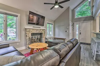 a living room with a couch and a fireplace at Unwind Fireside and Walk to Slopes! Poconos Getaway in Lake Harmony