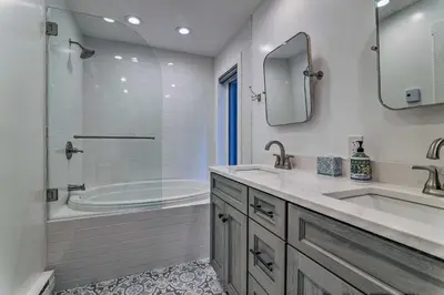a bathroom with a tub and a sink and a shower at Unwind Fireside and Walk to Slopes! Poconos Getaway in Lake Harmony