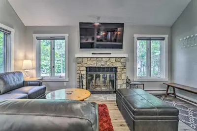 a living room with a couch and a fireplace at Unwind Fireside and Walk to Slopes! Poconos Getaway in Lake Harmony