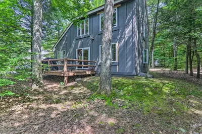 a gray cabin in the woods with trees at Unwind Fireside and Walk to Slopes! Poconos Getaway in Lake Harmony
