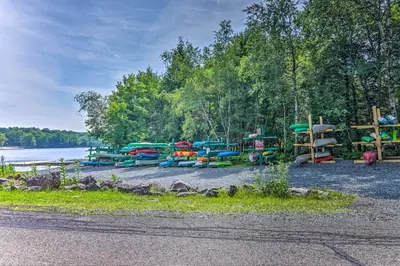 a group of colorful play structures next to a lake at Fire Pit and Community Perks Blakeslee Cottage! in Blakeslee