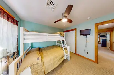 a bedroom with two bunk beds and a flat screen tv at Northridge 372 in Tannersville
