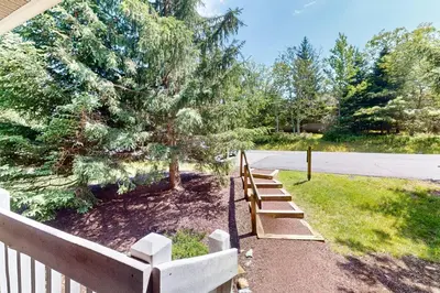 a row of wooden benches next to a fence at Northridge 372 in Tannersville